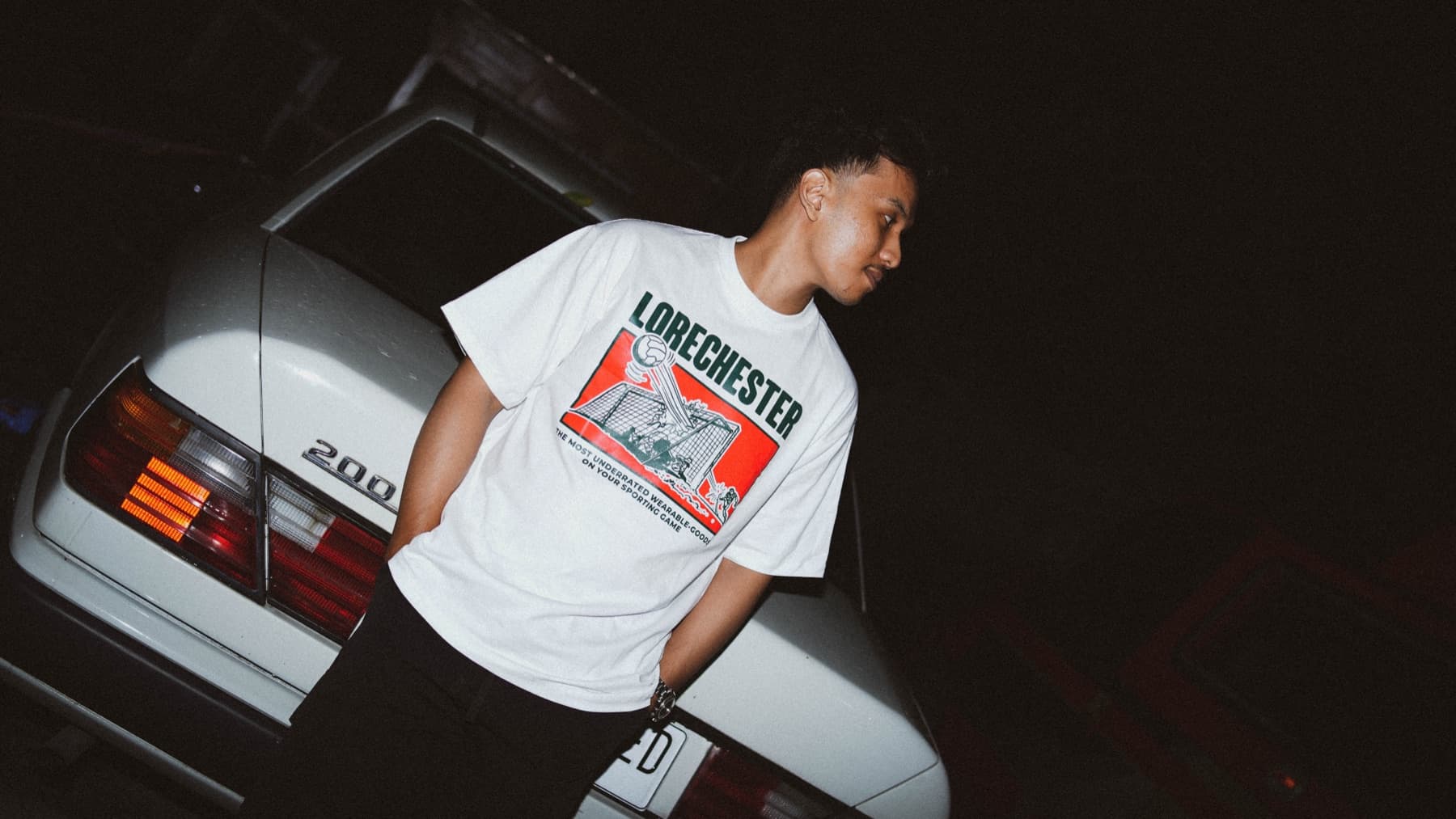 Goal Tee against a car at night