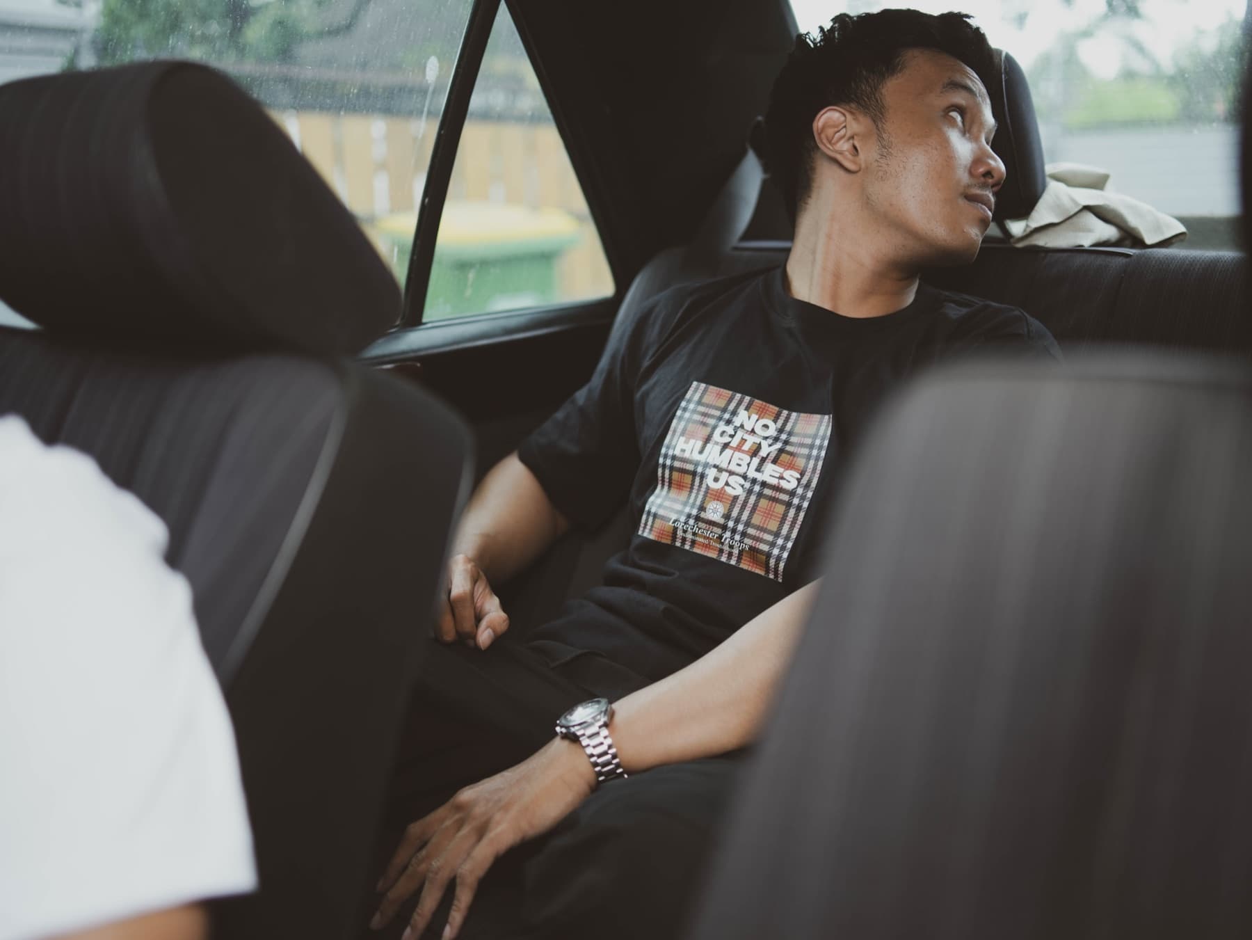 In the car, white tee